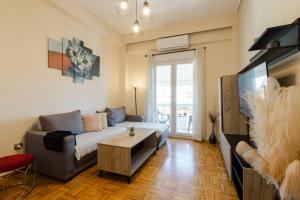 a living room with a couch and a table at Feel's Like Home Apartment in Chios Town in Chios