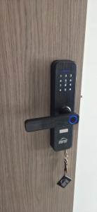 a door opener with a cell phone attached to it at Don Pedro in Buga