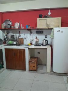 a kitchen with a sink and a refrigerator at Apartamento comodo in Asunción +2 photos