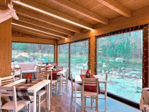 a restaurant with tables and chairs and a large window at La Baita Del Cervo 2 in Castel di Sangro