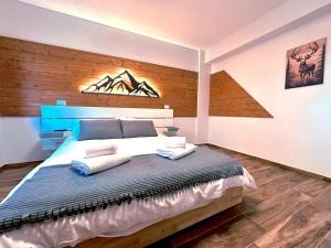 a bedroom with a large bed with a blue headboard at La Baita Del Cervo 2 in Castel di Sangro +45 photos