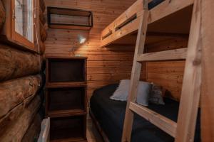 a bedroom with two bunk beds in a log cabin at Pikkukelo Ruka in Ruka