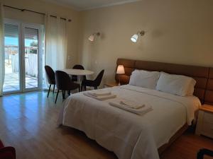 a bedroom with a bed and a table with chairs at Herdade do Montinho in Portalegre +69 photos