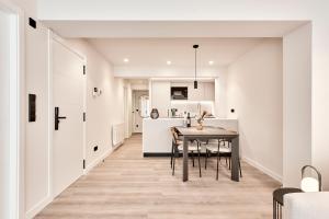 a kitchen and dining room with white walls and a table at AHH ATLANTIC HORIZON HOMES fa in A Coruña