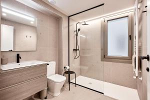 a bathroom with a toilet and a sink and a shower at AHH ATLANTIC HORIZON HOMES fa in A Coruña +32 photos