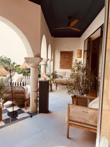 a patio with chairs and a fountain in a building at Hotel Villa Ruy López in Zafra