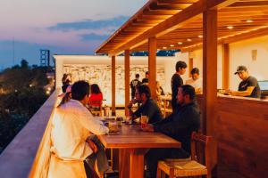 a group of people sitting at a table on a patio at Hotel Azul de Oaxaca in Oaxaca City