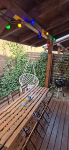 a wooden bench sitting on a deck with a swing at Costa Blanca Międzyzdroje - Holiday Home in Międzyzdroje