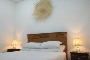 a bedroom with a white bed with two lamps on it at Tangier city center 1 in Tangier