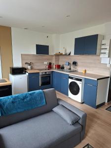 a living room with a couch and a kitchen at horizon doux in Calais
