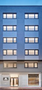 a tall blue building with many windows at AHH ATLANTIC HORIZON HOMES fa in A Coruña