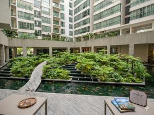 a building with a garden in the middle of it at Ehsan Suites in Kuala Lumpur