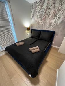 a bedroom with a bed with two pillows on it at Apartment Comfort Premium in Bartoszyce
