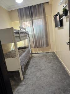 a bedroom with a bunk bed and a window at Apparemment à louer in Derroua