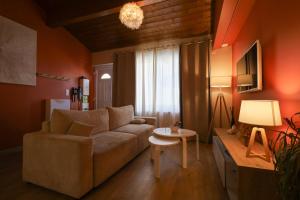 a living room with a couch and a table at Appartement le cocon de terre in Ambérieu-en-Bugey