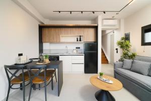 a kitchen and living room with a table and a couch at Videre Golden Private Pool Suites in Potamiá