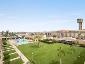 an image of a park in the middle of a city at Novotel Cairo Airport in Cairo