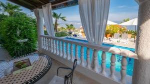 a balcony with a table and a view of a swimming pool at Apartments Barbara in Lovran