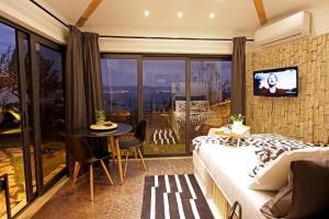 a bedroom with a bed and a table and a television at Apartments Barbara in Lovran