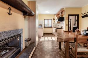 a kitchen and living room with a fireplace at Chalet Niki BELLAGIO in Bellagio