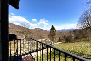 a balcony of a house with a view of the mountains at Chalet Niki BELLAGIO in Bellagio