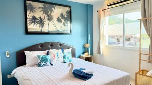 a bedroom with a bed with a swan on it at DANK Hotel 420 friendly Patong Phuket in Patong Beach