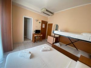 two bunk beds in a room with a mirror at Hotel HARRY'S Hospitality Riccione-Fronte Mare in Riccione