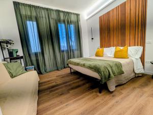 a bedroom with a bed with yellow pillows at Chianciano Lettings -Room and Apartments- in Chianciano Terme