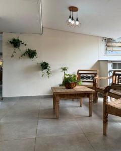 a room with a table and chairs and plants on the wall at ALVORADA PALACE HOTEL in Bauru