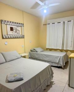 a hospital room with two beds and a window at ALVORADA PALACE HOTEL in Bauru