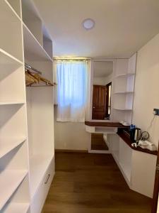 a room with white shelves and a window at Seaside Drift in Huraa +32 photos