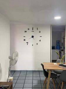 a clock on a wall in a room at Tu depa en SLP in San Luis Potosí +2 photos