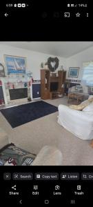 a view of a living room with a couch and a tv at Beach House Overlooking Lake Michigan in Algoma