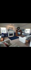 a living room with a couch and a tv at Beach House Overlooking Lake Michigan in Algoma