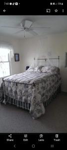 a bedroom with a bed with a comforter on it at Beach House Overlooking Lake Michigan in Algoma