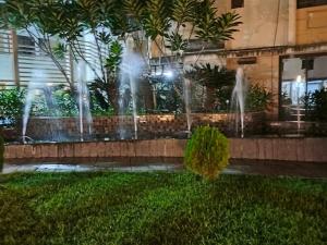 a group of water fountains in front of a building at Starlight Guest House in kolkata
