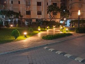 a courtyard at night with lights and a building at Starlight Guest House in kolkata +3 photos
