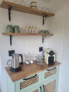 a kitchen with a counter with a toaster and appliances at Au Coin du Chêne in Thaon-les-Vosges