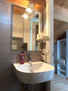 a bathroom with a white sink and a mirror at Suite Aura Marina in Civitanova Marche