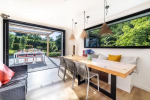 a kitchen and dining room with a table and chairs at Small house with swimming pool and jacuzzi in Biarritz