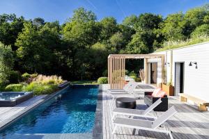 a backyard with a swimming pool and a house at Small house with swimming pool and jacuzzi in Biarritz