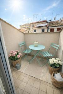 a patio with a table and chairs on a balcony at Suite Aura Marina in Civitanova Marche