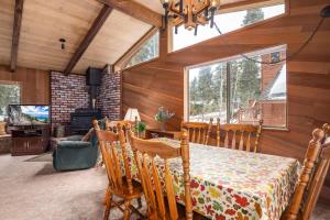 a dining room with a table in a room with wood walls at Villa Bossi in Carnelian Bay