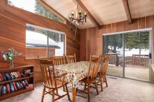 a dining room with a table and chairs and a window at Villa Bossi in Carnelian Bay
