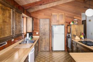 a kitchen with wooden cabinets and a white refrigerator at Villa Bossi in Carnelian Bay
