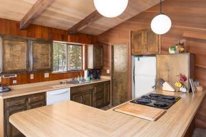 a kitchen with wooden cabinets and a white refrigerator at Villa Bossi in Carnelian Bay +15 photos