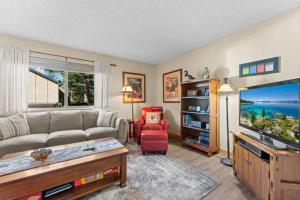 a living room with a couch and a tv at Cozy Bear's Lair in Tahoe City
