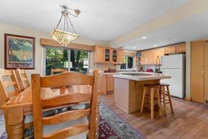a kitchen with a wooden table and a dining room at Cozy Bear's Lair in Tahoe City +27 photos