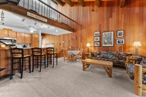 a living room with wooden walls and a table and chairs at Twisted Retreat in Kings Beach
