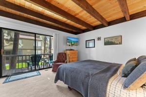 a bedroom with a large bed and a balcony at Twisted Retreat in Kings Beach
